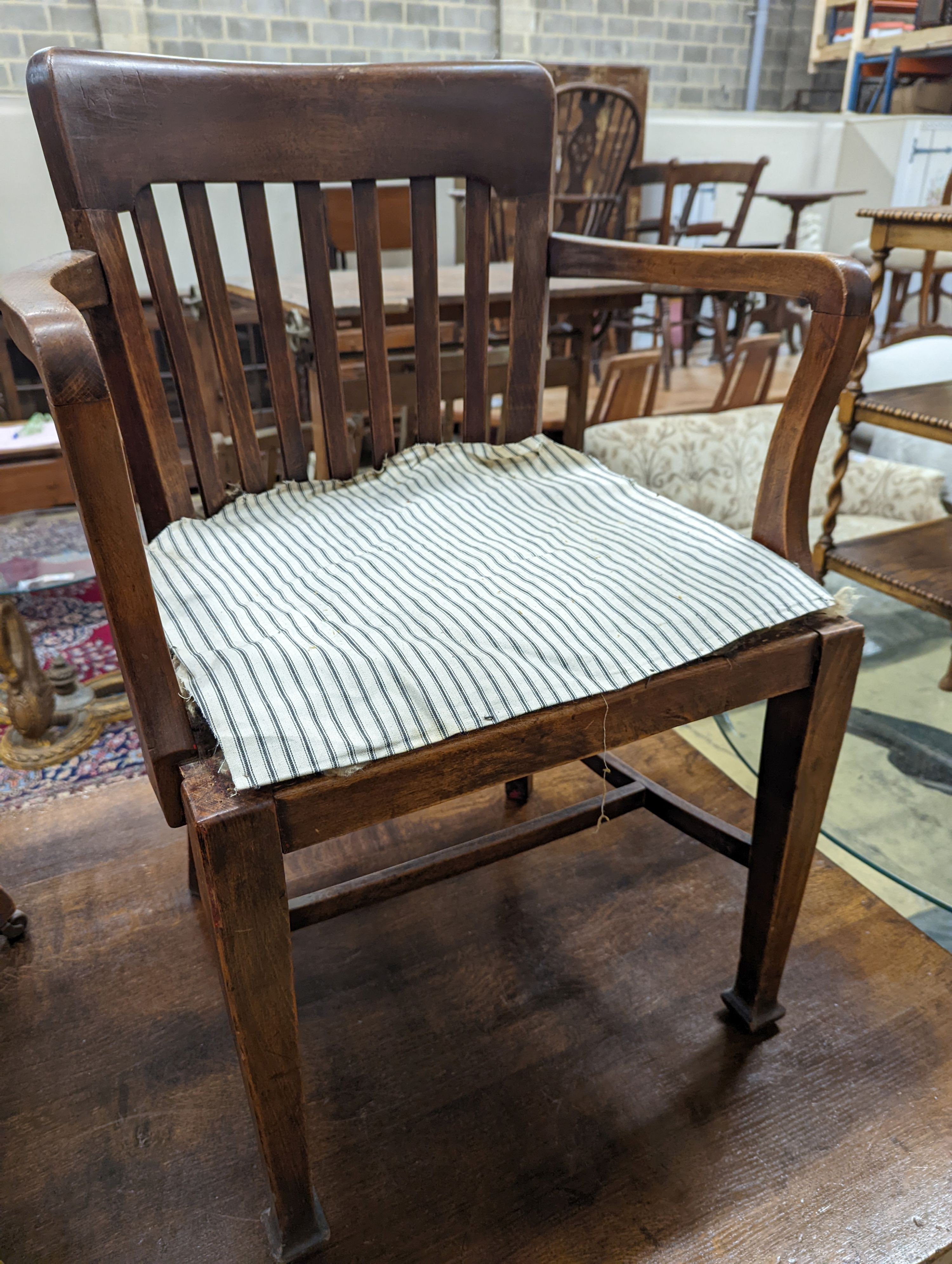 Two early 20th century swivel desk chairs and another chair.